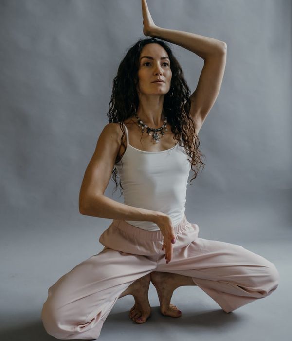Woman in a graceful yoga pose representing inner balance and strength.